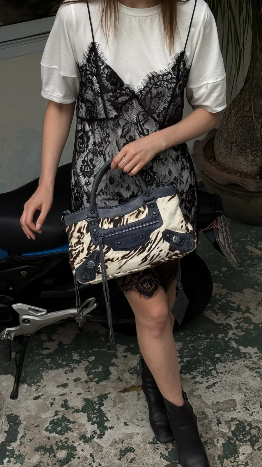 A vintage Balenciaga bag in pony hair, carried with a lace slip dress